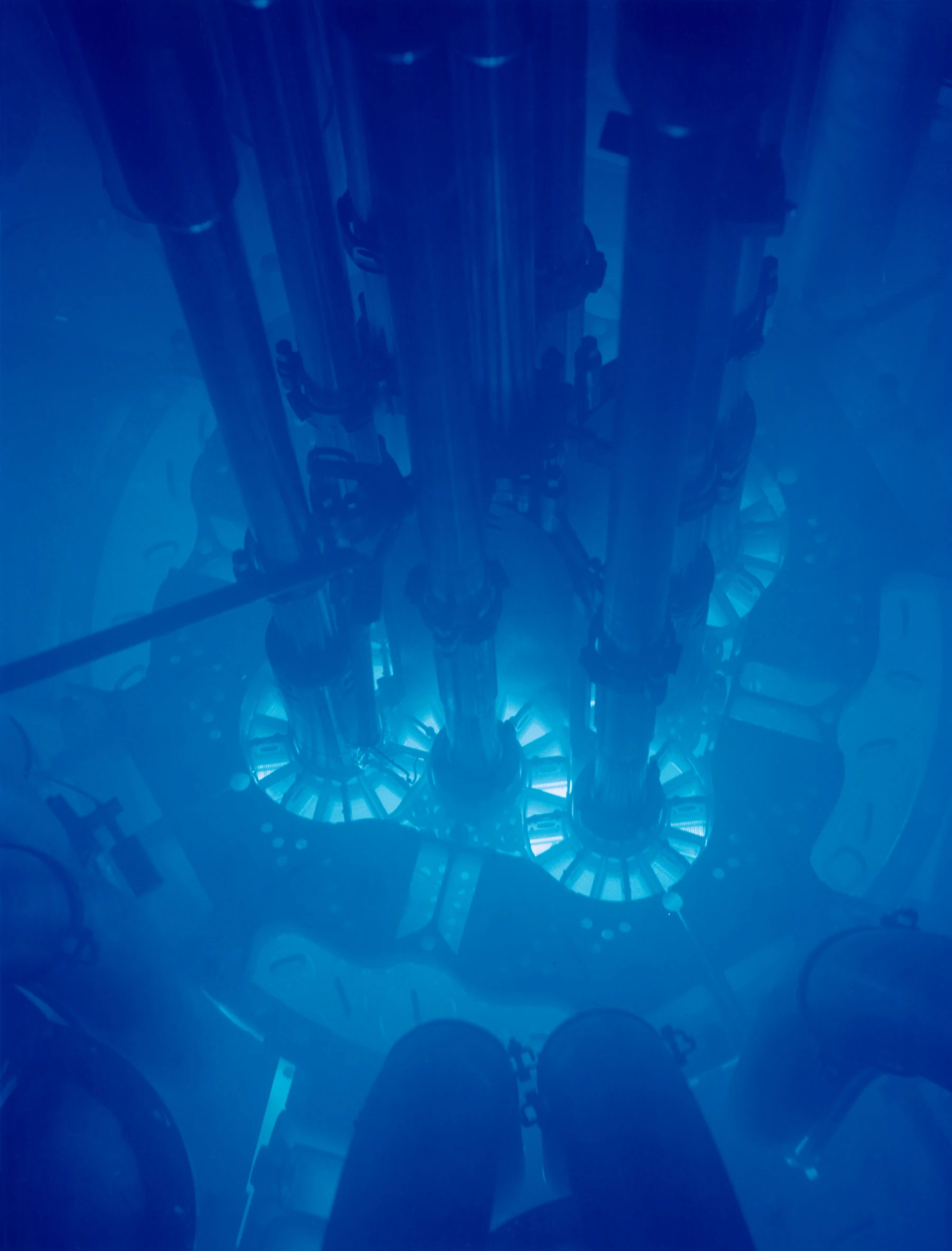 The submerged core of the Advanced Test Reactor in Idaho, illuminated by a blue glow.